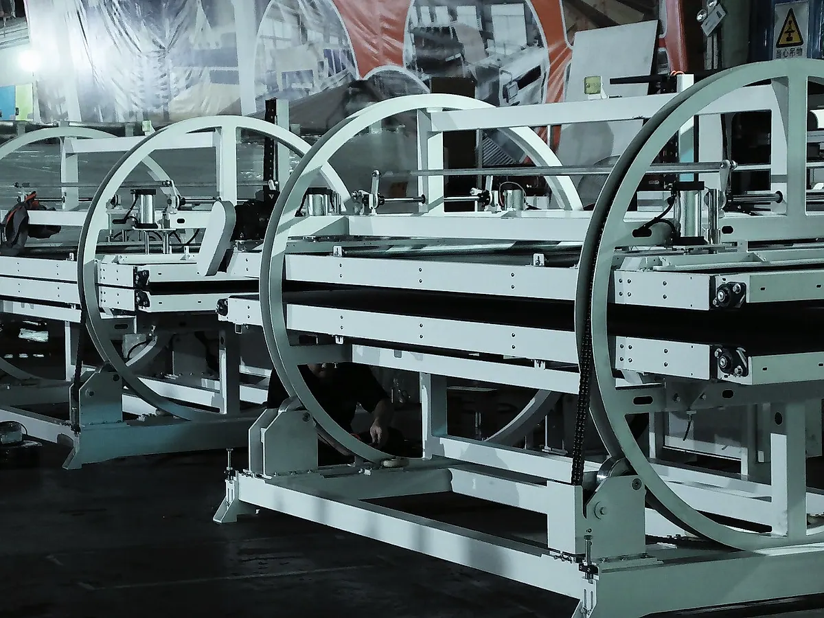 FORTRAN technicians checking a panel turnover machine during assembly