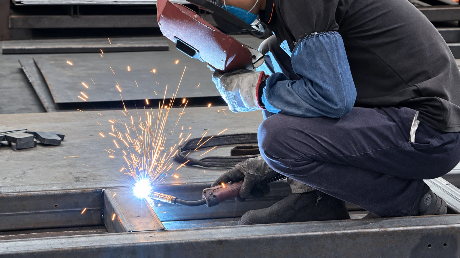 FORTRAN workshop technician welding a steel equipment frame
